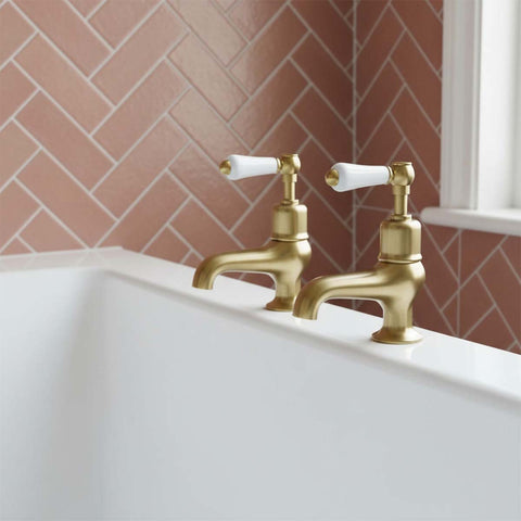 Brushed brass traditional bath filler taps with white handles