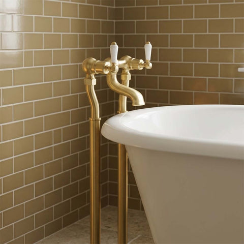 brushed brass floorstanding bath filler with white ceramic levers 