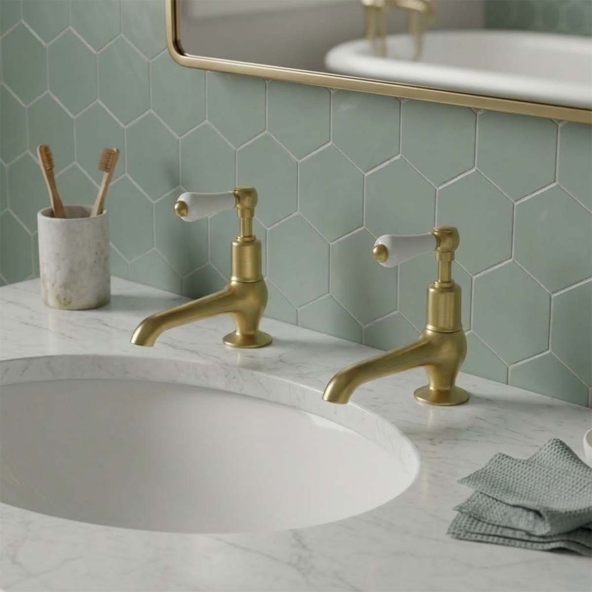 traditional brushed brass basin pillar taps with white ceramic handles 